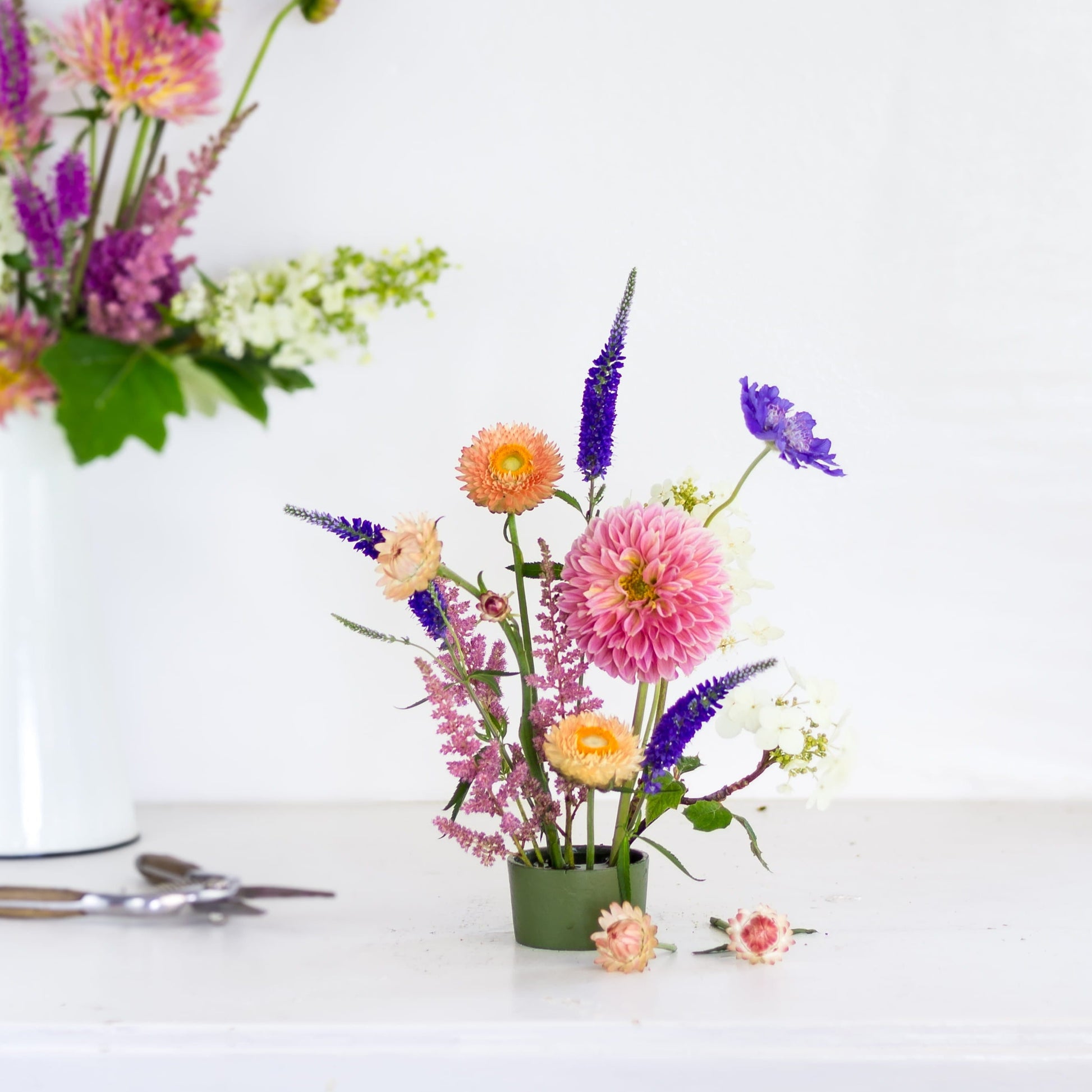 Flowers in a green Floral Genius flower frog pin cup