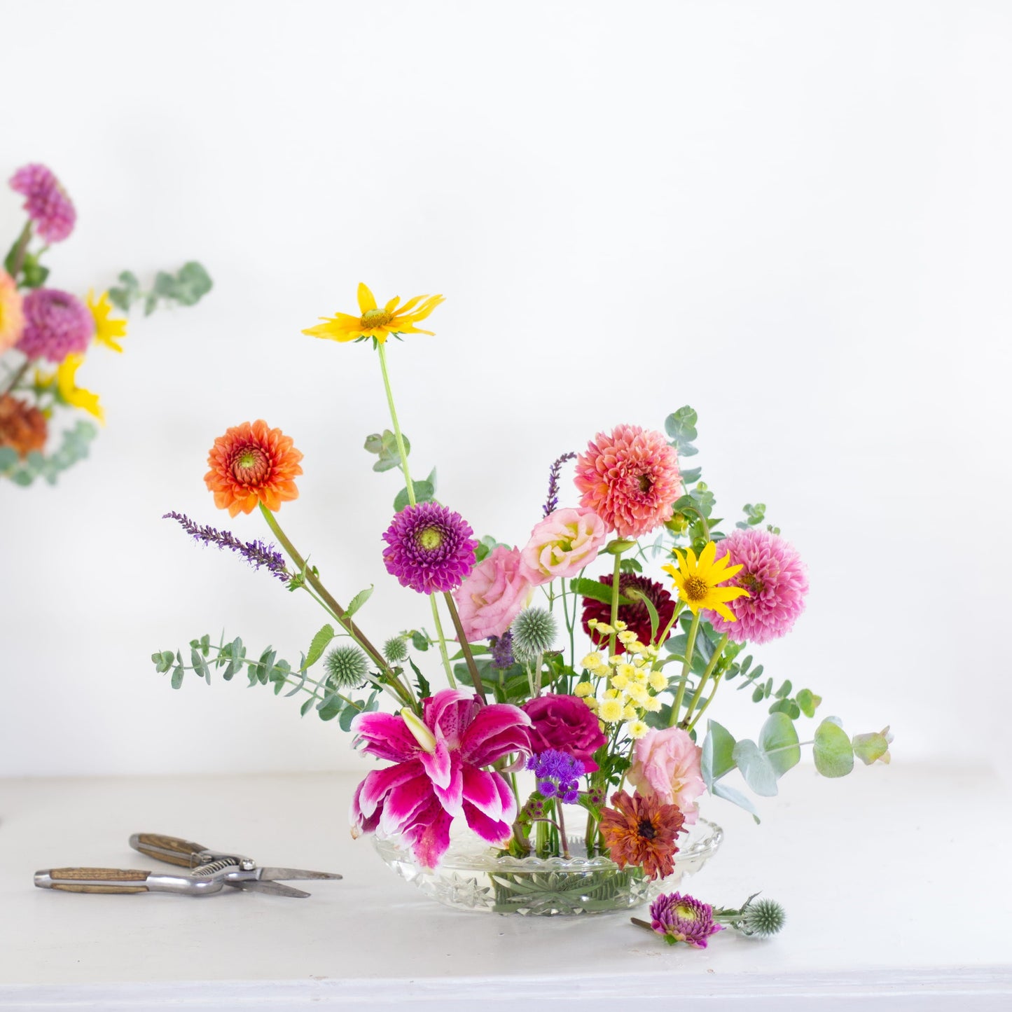 Oval kenzan flower frog in clear vase with flowers made by Floral Genius