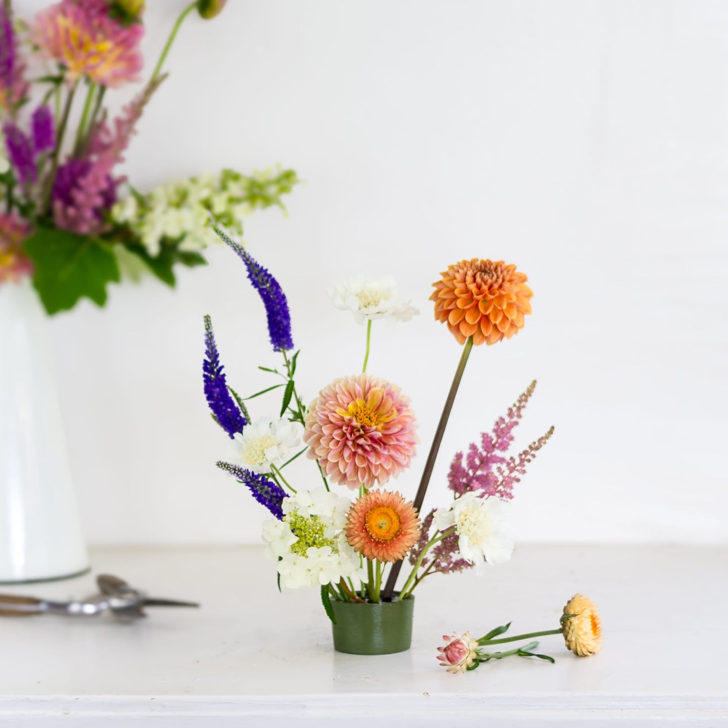Small round pin cup flower frog kenzan with flowers made by Floral Genius